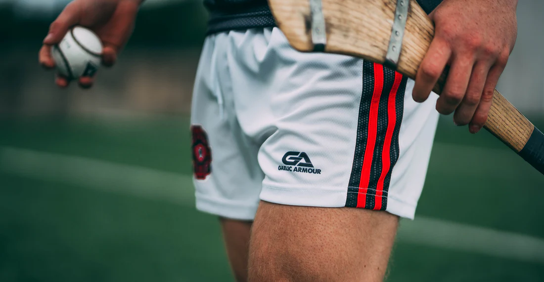 a hurler wearing GAA shorts